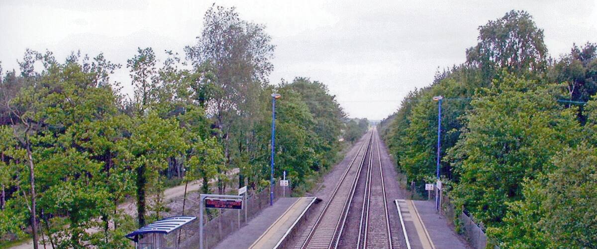 A railway station with multiple tracks and a shelter.