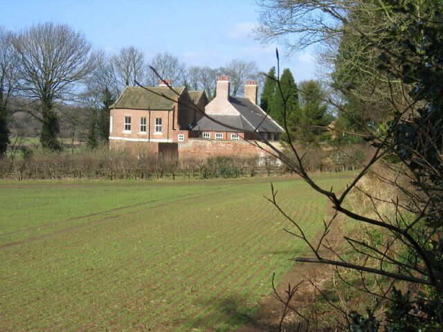 Shincliffe Hall Keys to the Past Web Site: Shincliffe Hall was built as a house in about 1771, though it is now occupied by Durham University Graduates. SHINCLIFFE HALL LANE NZ 2840 (South end, off) 13/89 Shincliffe Hall GV II House, now occupied by Durham University Graduates' Society. Circa 1771 for William Rudd, with C20 alterations. Narrow brick in Flemish bond with painted stone dressings. Main block has graduated stone tiles on roof; wing has Welsh slate roof. Old brick chimney stacks. Double-span main block with contemporary wing set corner-to-corner on right rear. 2-storey, 3-bay garden front has band between storeys and replaced sashes with projecting stone sills and segmental brick heads. Late C20 addition on ground- floor right bay. Steeply-pitched 2-span roof with stone-coped gable parapets and shaped kneelers. Tumbled-in brickwork on gables. Twin-gabled returns: 2-storey canted brick bay, with replaced sashes and hipped roof, on left return of front range; some 12-pane sashes on left return of rear range; 2-storey late C19 lean-to addition on right return. Tripartite sash window and early C20 glazed octagonal porch on rear of main block. 3-bay wing, of 2 storeys and attics,has mainly replaced sashes, some in altered openings,and a catslide roof with transverse end stacks. Lower 2-storey rear facing courtyard. Interior: main block contains cut-string, open-well staircase, of 3 flights plus landing rail, with 2 turned balusters per tread and a ramped and wreathed handrail. Staircase hall has modillion cornice. 6-panel doors in architraves with panelled reveals. Late C20 flat-roofed addition on right ground-floor bay of garden front is not of interest.