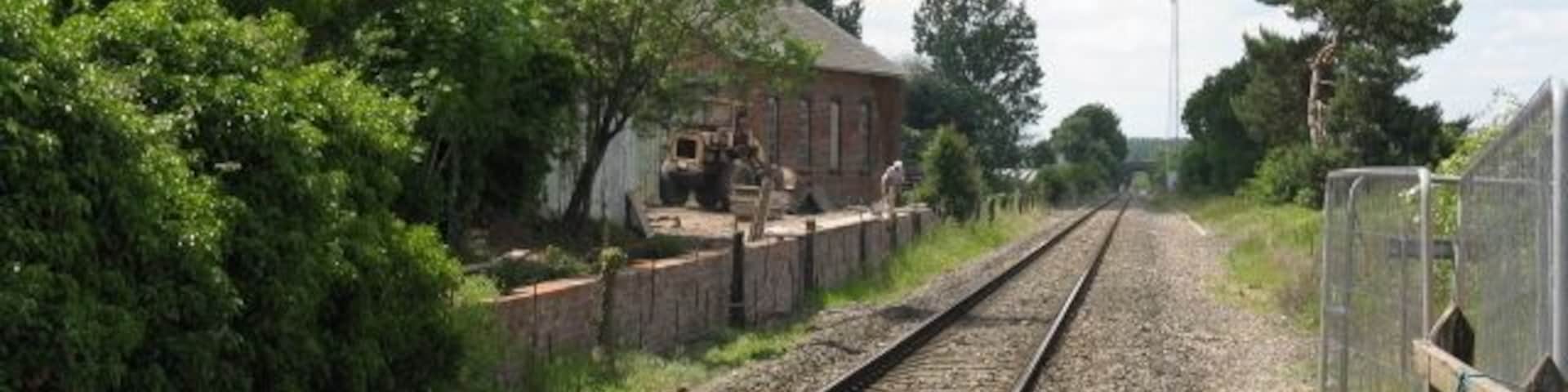 Stoke Edith Station & Goods Shed Looking west from the level crossing, Before 1984 when the line was singled a signalbox would have stood where a large tree now thrusts. The goods shed is a 2004 reconstruction of the original, part of a collection of railway artefacts held privately at the former station.