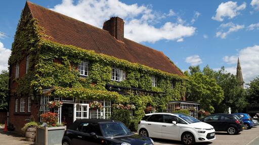 The Crown public house covered by Boston Ivy, with car park including a Mini Cooper and a Citroën C4 Picasso, at 45 Newgate Street Village (name of road), at Newgate Street, in the civil parish of Hatfield, and the Borough of Welwyn Hatfield, Hertfordshire, England. Camera: Canon EOS 6D with Canon EF 24-105mm F4L IS USM lens. Software: file lens-corrected and optimized with DxO OpticsPro 10 Elite and Viewpoint 2, and further optimized with Adobe Photoshop CS2.