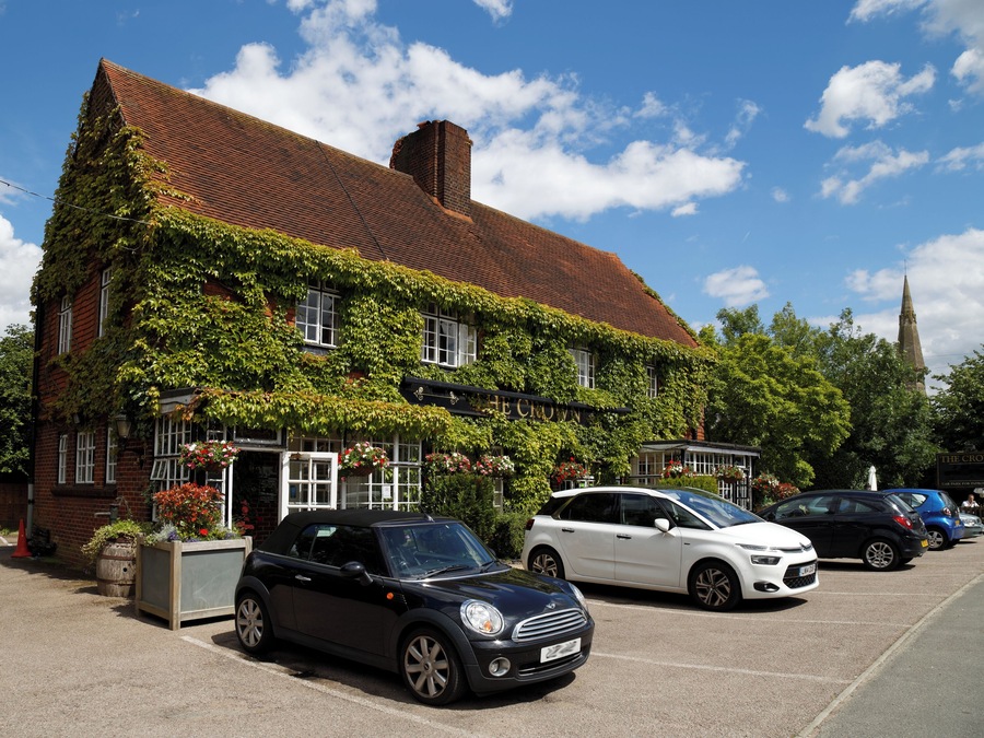 The Crown public house covered by Boston Ivy, with car park including a Mini Cooper and a Citroën C4 Picasso, at 45 Newgate Street Village (name of road), at Newgate Street, in the civil parish of Hatfield, and the Borough of Welwyn Hatfield, Hertfordshire, England. Camera: Canon EOS 6D with Canon EF 24-105mm F4L IS USM lens. Software: file lens-corrected and optimized with DxO OpticsPro 10 Elite and Viewpoint 2, and further optimized with Adobe Photoshop CS2.