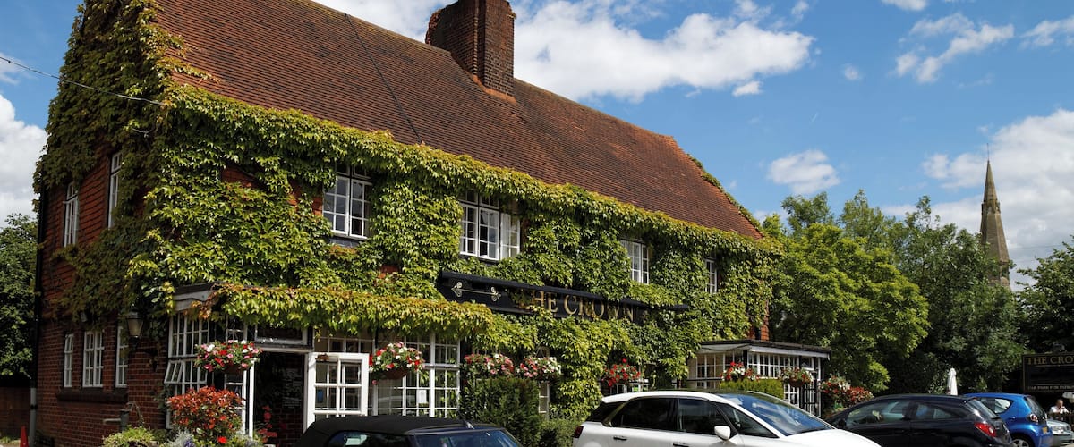A historic building with ivy-covered walls and a traditional red-tiled roof.