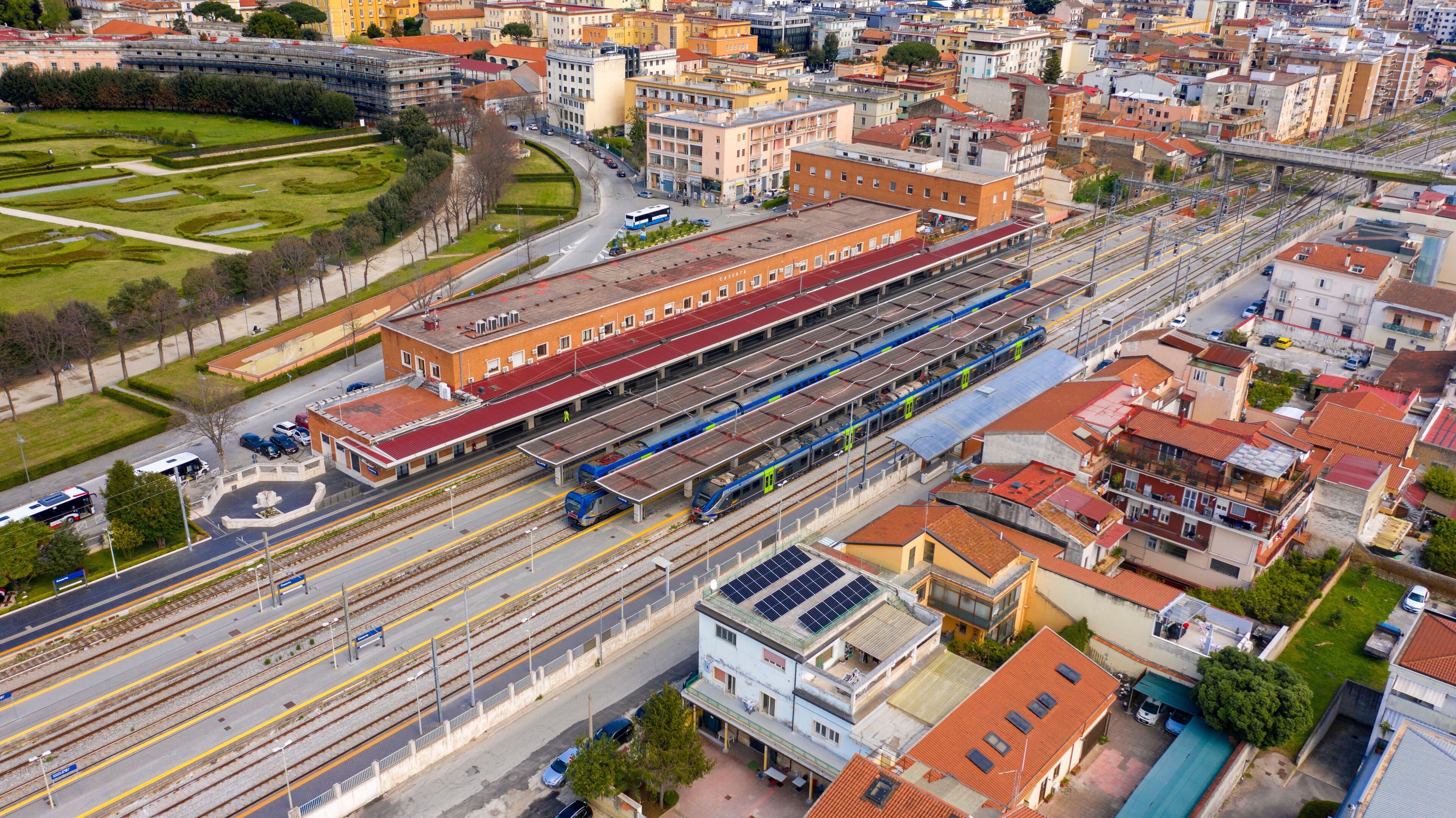 A train station with multiple tracks and a train on the platform.