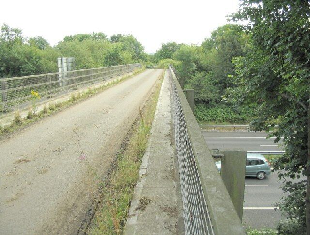 Minor road bridge across the M4. A narrow bridge rejoining a lane interrupted by the M4 motorway. The lane leads to a farm track and to a scout camp facility. It's unbelievable how full sized coaches can reach that place down this kind of road.