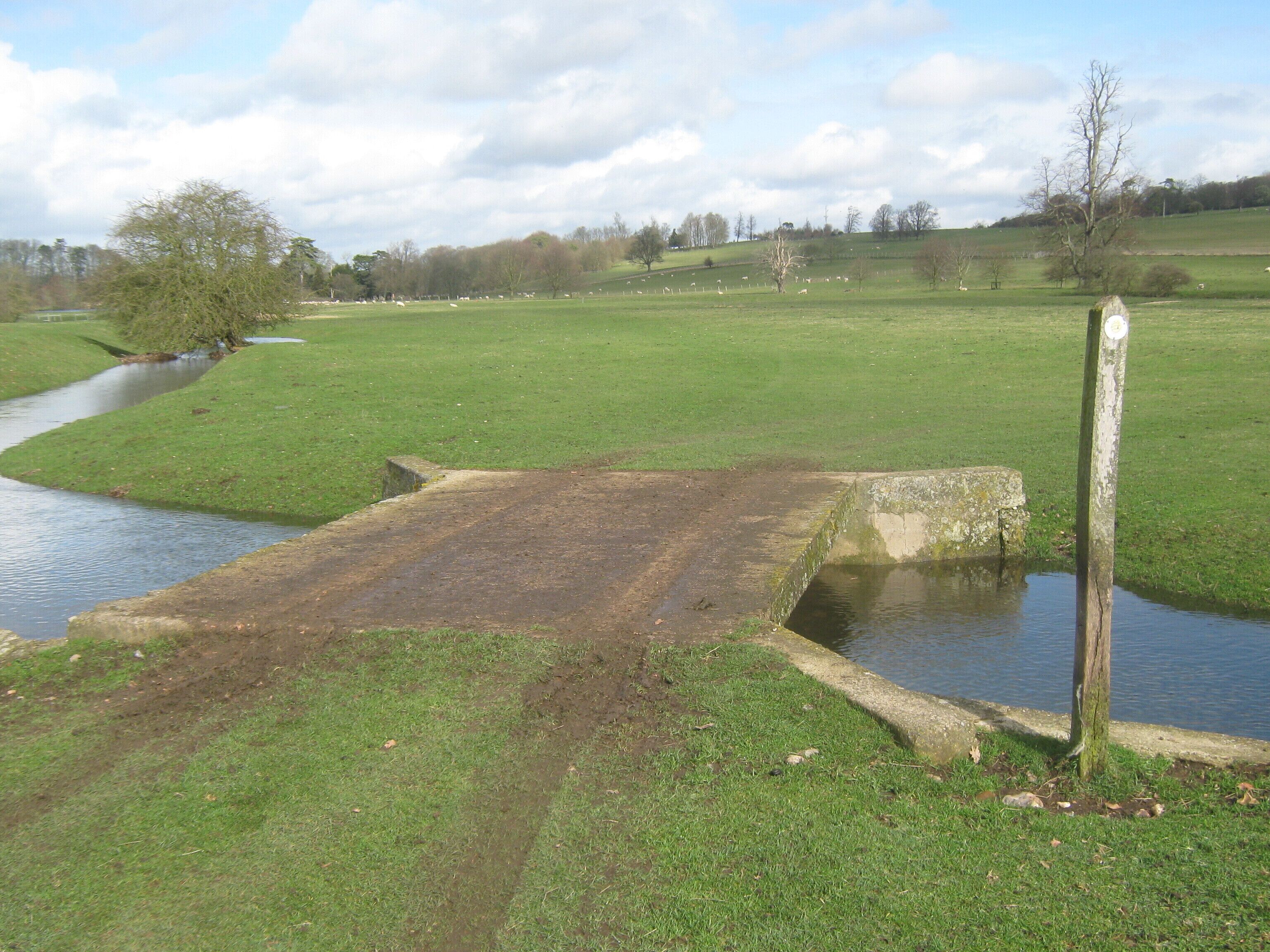 Bridge on Elham Valley Way The long distance walk heads over a farm bridge (over the River Nailbourne) in a sheep pasture near Bourne House, the path leads towards Bourne Park Road.