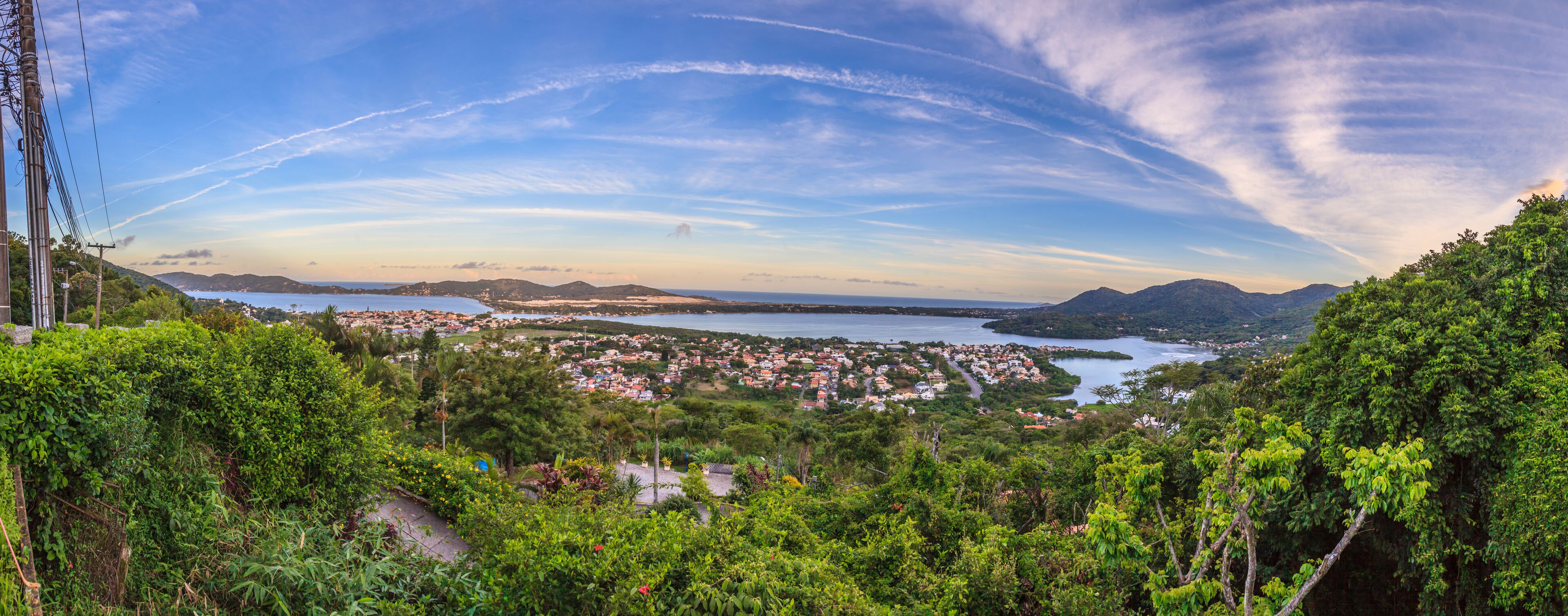 A coastal town with a view of the sea and mountains in the background.