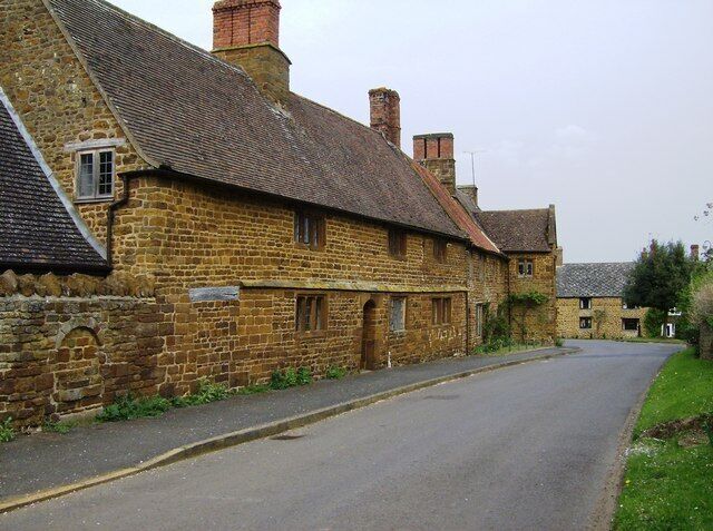 School Lane, Eydon, Northamptonshire: view toward T-junction with High Street (left) and The Green (right). On the left are 2, 4 & 6 School Lane: "Tudor Cottages" (nearest camera) and "Tudor House" (with gabled porch).