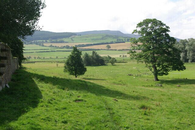 Coquetdale from Wreighburn House From Wreighburn House the land falls away to the River Coquet. In the distance are the Simonside Hills.