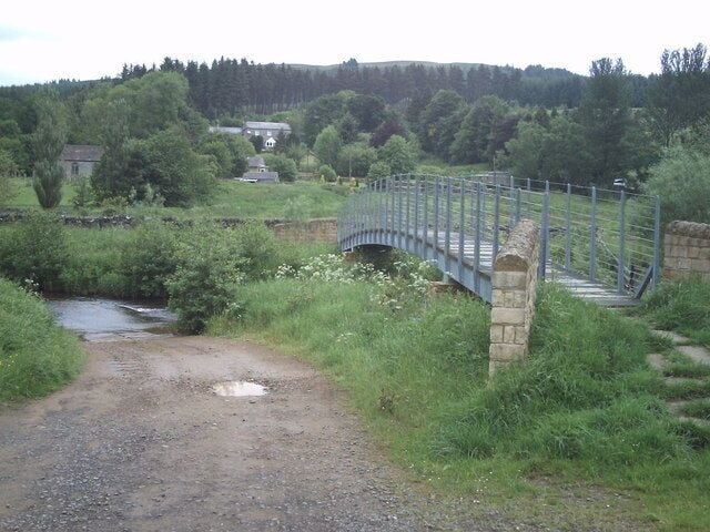 Footbridge over the Rede Footbridge and ford across the River Rede near Byrness. Byrness church can be seen to the left of the photograph.