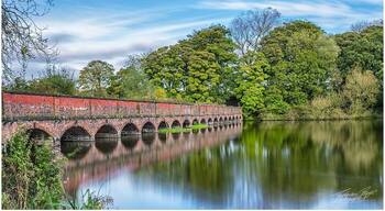 Reflections from the 19 arch bridge at Carr Mill Dam in St Helens, Merseyside