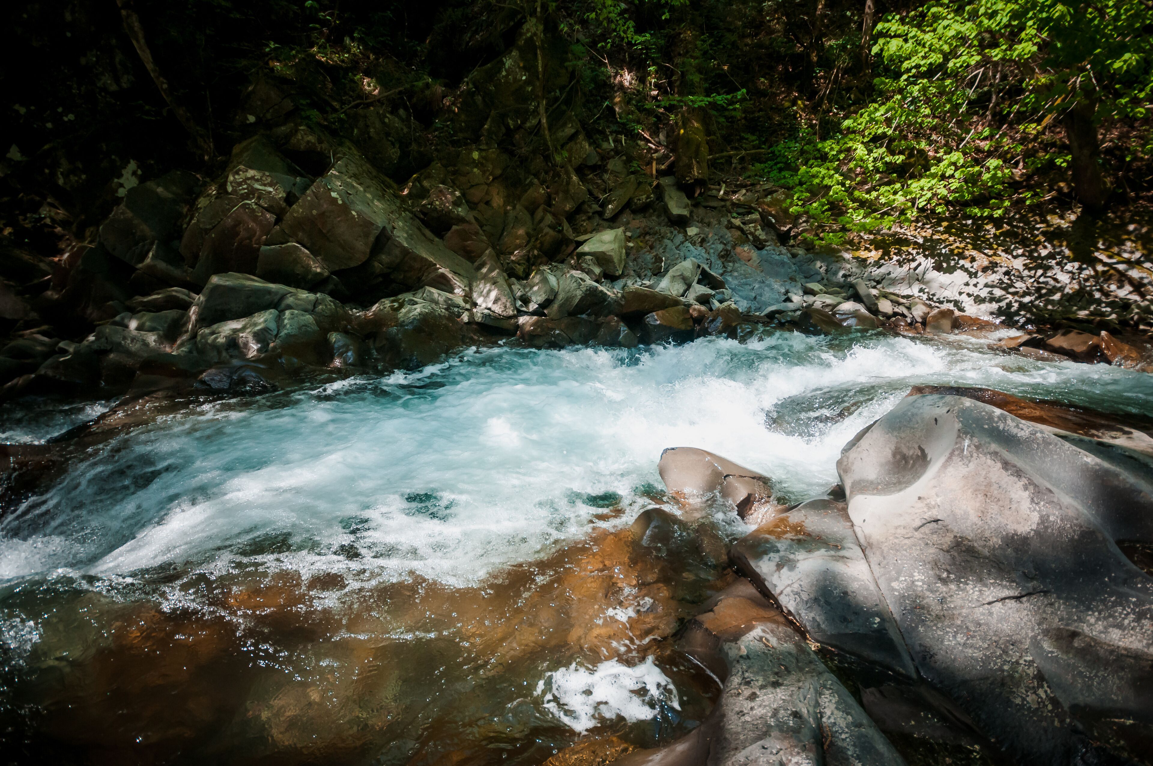 Blue Lagoon, mountain river among the rocks in the forest
