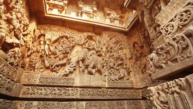 India Belur temple. Old stone wall with sculptures