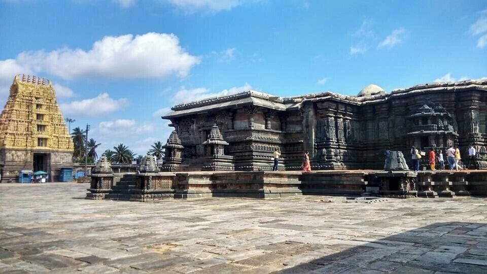 A temple complex with intricate stone carvings and a large pyramid-like structure.