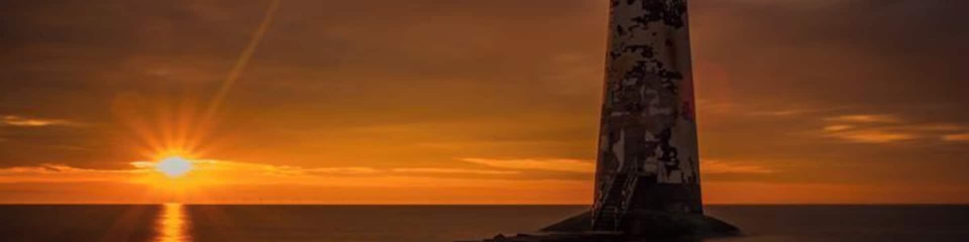 Abandoned lighthouse on Talacre Beach, North Wales. Sunset or Sunrise are the best time to photograph, especially during the summer months. The beach is tidal so check the tide times. Behind the lighthouse are sand dunes. During the summer months you can use the beach car-park, subject to tidal conditions. It's locked if there is a really high tide. The beach car park is locked after 9pm during summer months and 7pm during winter months. Check local notices of closure times. You can park in the village, local council car park, 20 pence for two hours or £2 all day.
