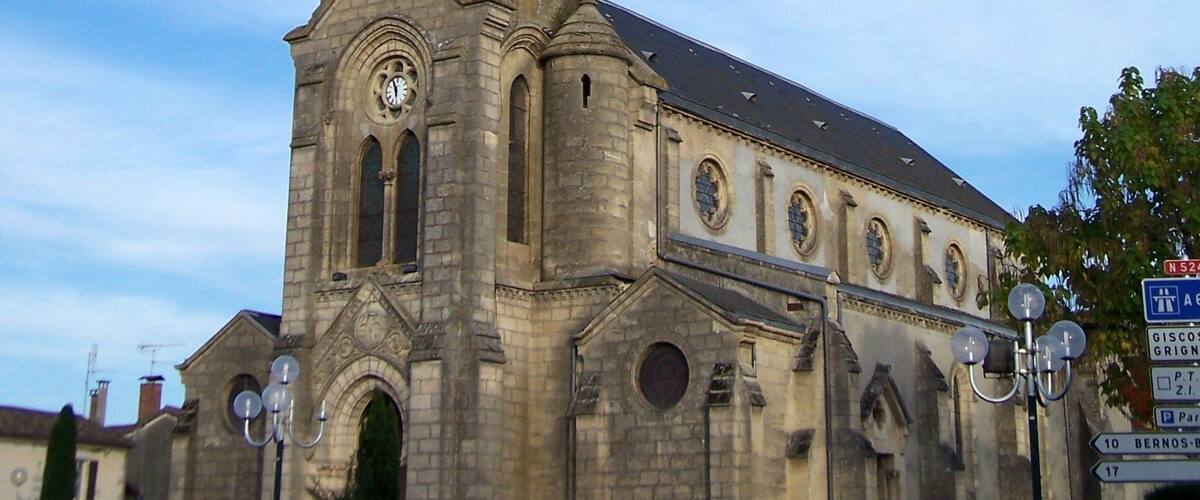 A historic church with a tall bell tower and a clock.