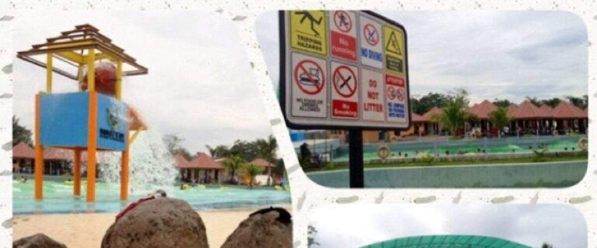 A water park with a water slide, a pool with lounge chairs, and a sign with various warnings.