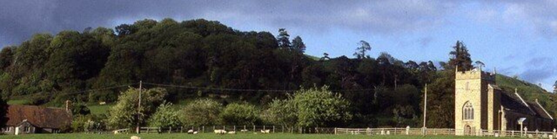 Holy Trinity, Sutton Montis Retrospective view back to the church in Sutton Montis while walking the Leland Trail. The tree covered hill to the left conceals Cadbury Castle