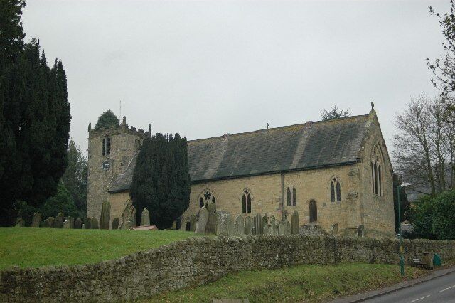 A historic church with a stone facade, arched windows, and a tower.