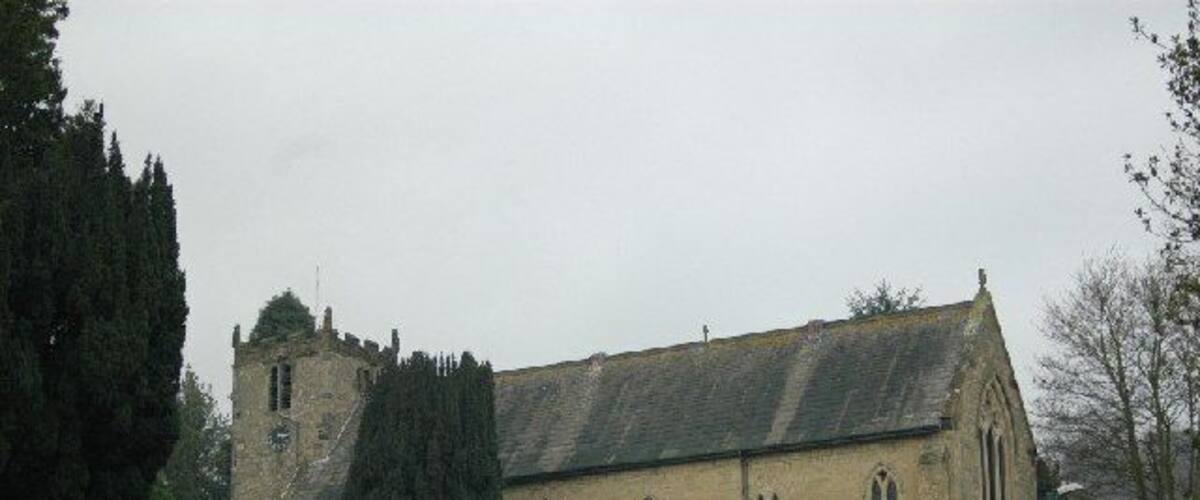 A historic church with a stone facade, arched windows, and a tower.