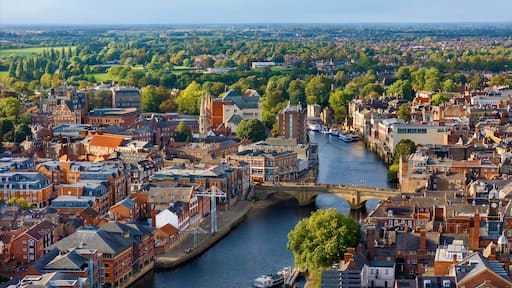 A river flowing through a historic town with bridges and buildings.