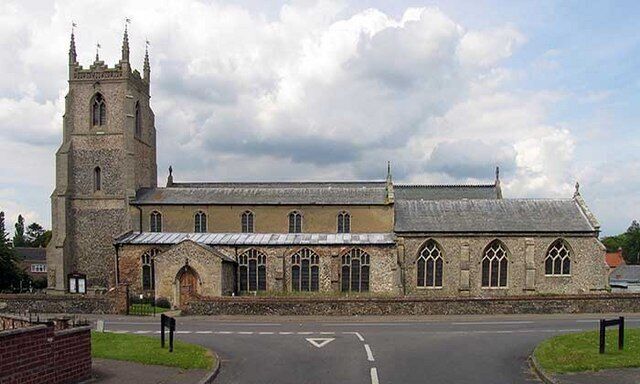 A historic church with a prominent tower and arched windows.