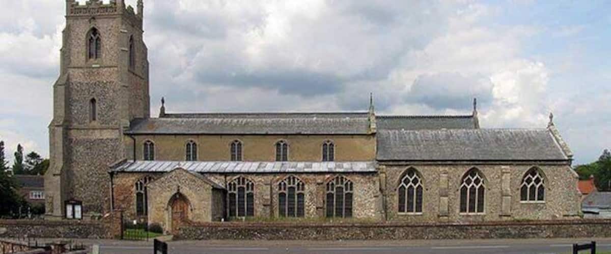 A historic church with a prominent tower and arched windows.
