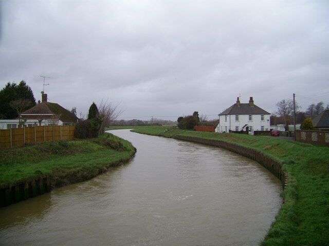 The Adur between Bramber and Beeding On a stormy New Year's Eve, the tide was just turning, bringing down tons of silt from the Downs and Weald. The pub to the left of the picture has a crisp munching great dane!