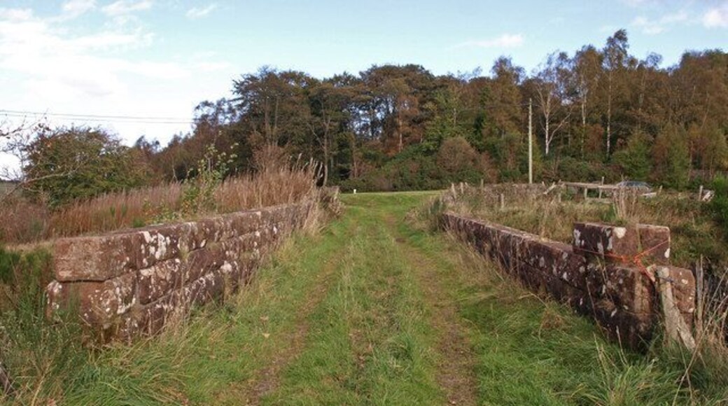 Bridge near Auchenbothie Mains Farm. This bridge carries a farm track which leads to Auchenbothie Mains Farm across the National Cycle Route 75 which uses the former Glasgow-Princes Pier railway line. For a different view of the bridge see693489.
