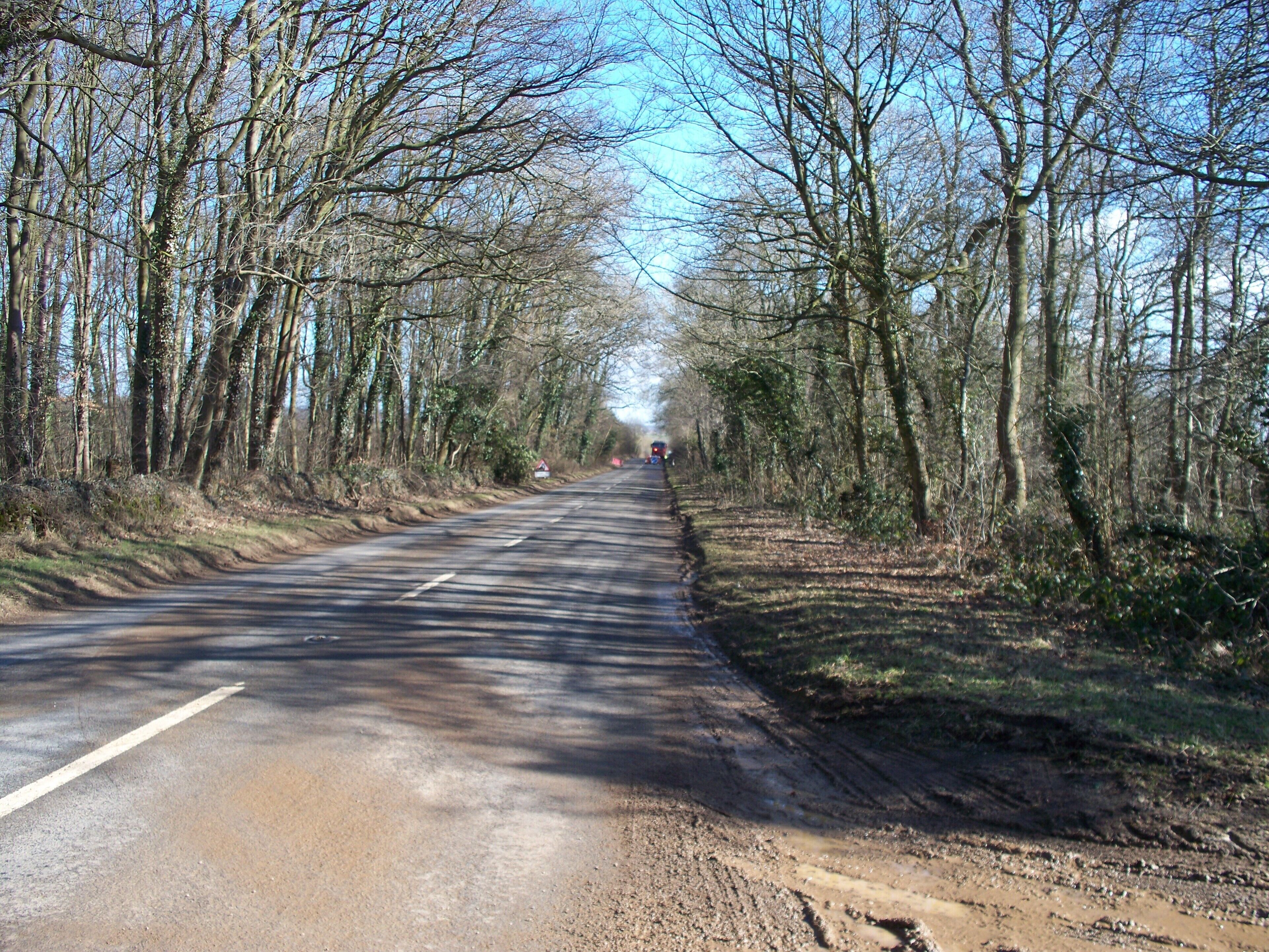 Road to Stow The B4077 seen from the point where the track from Lower Barn joins. The roadworks ahead are repairing the ravages of the 2009/10 winter.