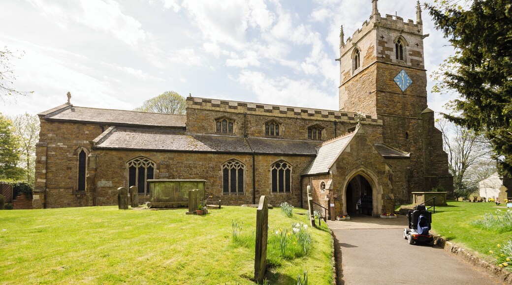 The church dates from the 11th century onwards and was rebuilt and restored in the 19th century. Certainly there was a church here in Saxon times and the lower part of the tower is probably Saxon, from around 1050. There is a west tower, nave with clerestory and north and south aisles, north porch, vestry and chancel. The tower is built in ironstone and dates from the mid-12th century. It is thought that the lower stage the tower could have been a Norman porch to the old church. The second stage is Early English and the top stage is Perpendicular. The tower has an embattled parapet with pinnacles and gargoyles. The tower arch has zigzag decoration. There are eight bells. The nave has four-bay arcades with octagonal piers and four clerestory windows either side. The chancel arch is from the 13th century. It is thought that the church may have been intended as being a cruciform shape with a crossing, or it may indeed have once been like this. The chancel was largely rebuilt in 1848 and restored in 1873. The reredos is from that date. There are several effigies of Knights set into arched tombs in the wall. There is a triple lancet east window, and stained glass from a variety of makers. The organ is by Cousans, and was installed in 1885. The rood beam is by Wilfrid Bond, erected in 1929.