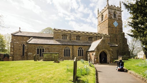 The church dates from the 11th century onwards and was rebuilt and restored in the 19th century. Certainly there was a church here in Saxon times and the lower part of the tower is probably Saxon, from around 1050. There is a west tower, nave with clerestory and north and south aisles, north porch, vestry and chancel. The tower is built in ironstone and dates from the mid-12th century. It is thought that the lower stage the tower could have been a Norman porch to the old church. The second stage is Early English and the top stage is Perpendicular. The tower has an embattled parapet with pinnacles and gargoyles. The tower arch has zigzag decoration. There are eight bells. The nave has four-bay arcades with octagonal piers and four clerestory windows either side. The chancel arch is from the 13th century. It is thought that the church may have been intended as being a cruciform shape with a crossing, or it may indeed have once been like this. The chancel was largely rebuilt in 1848 and restored in 1873. The reredos is from that date. There are several effigies of Knights set into arched tombs in the wall. There is a triple lancet east window, and stained glass from a variety of makers. The organ is by Cousans, and was installed in 1885. The rood beam is by Wilfrid Bond, erected in 1929.