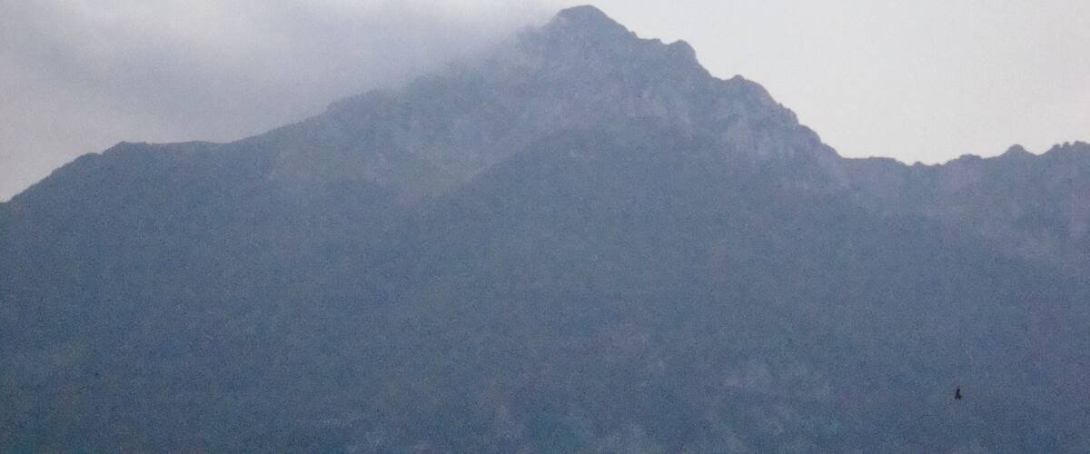 A mountain partially obscured by clouds.