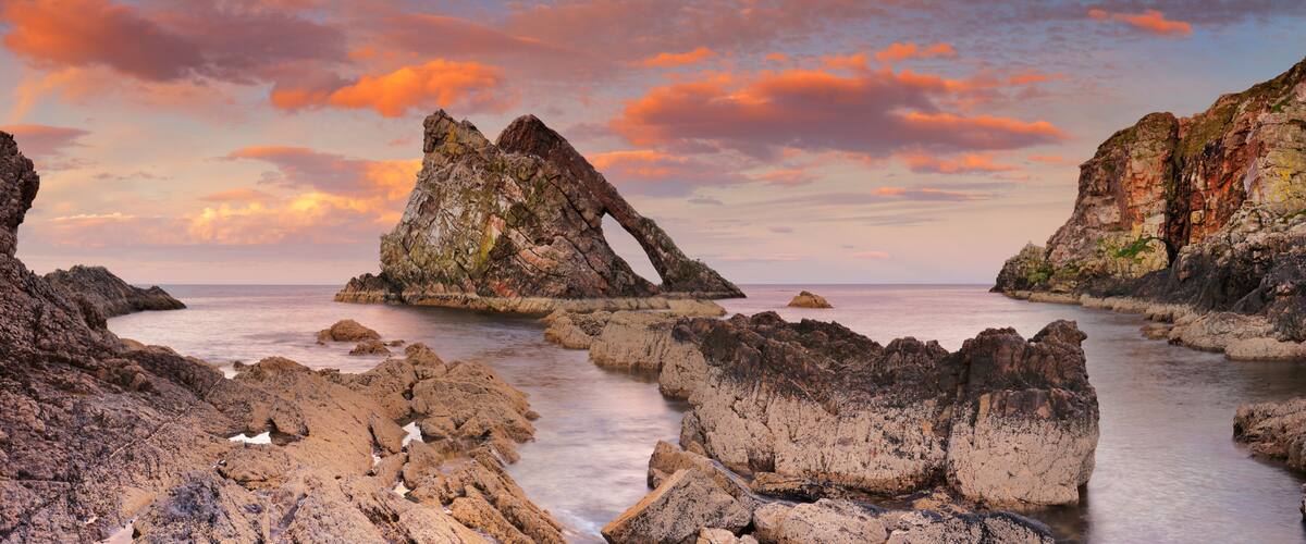 Bow Fiddle Rock, natural arch on Moray coast, Scotland, sunset