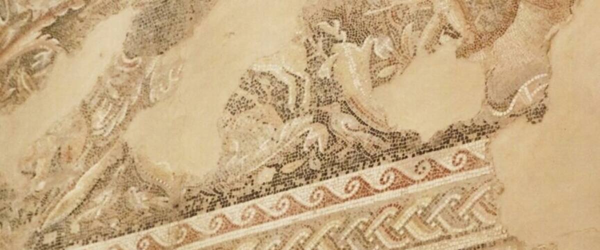 A detailed mosaic with geometric patterns and classical figures.