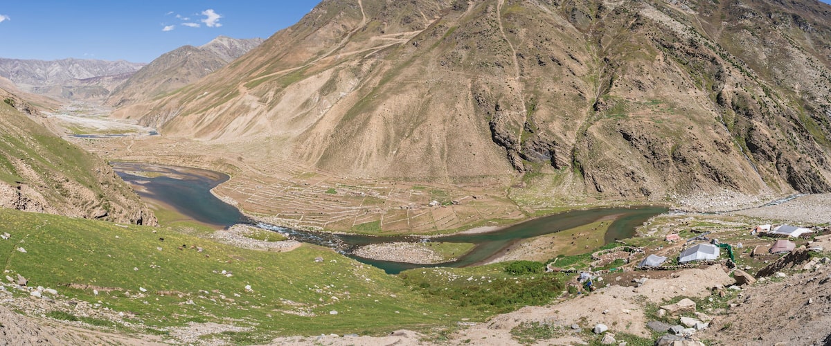 A mountainous landscape with a river flowing through a valley.