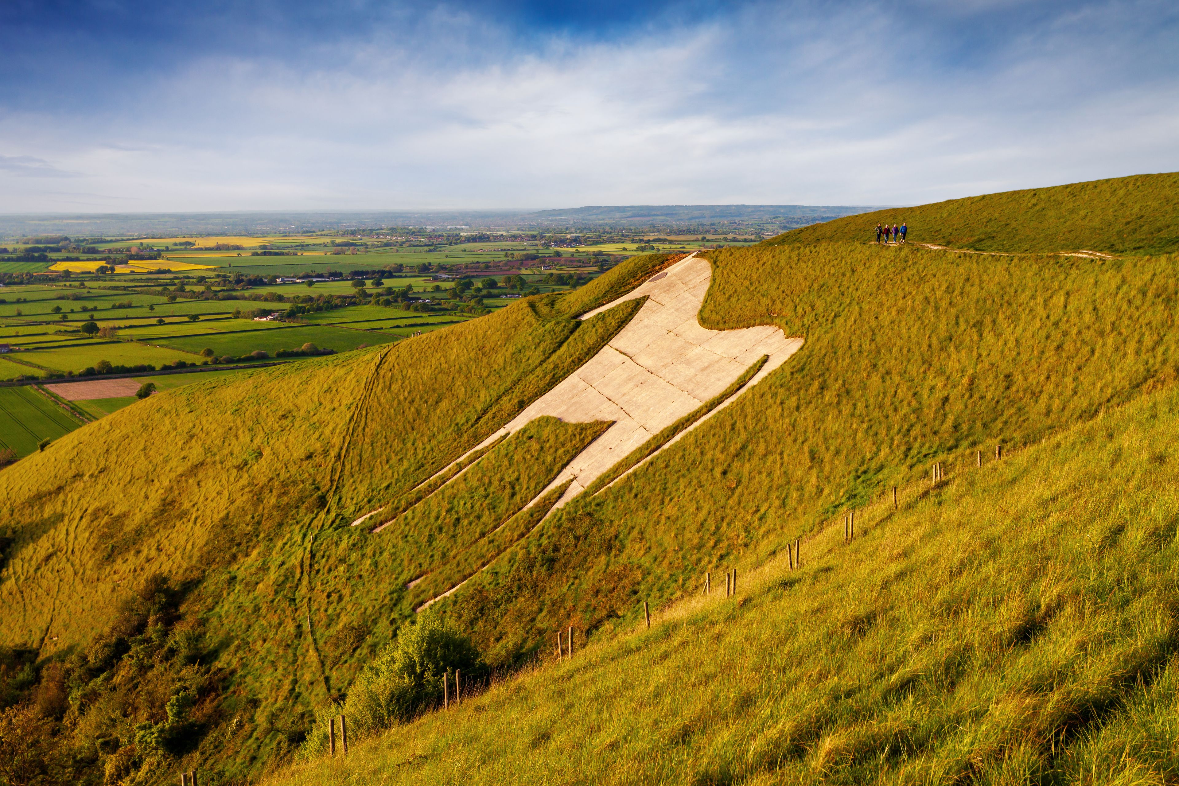 A grassy hill with a concrete structure resembling a giant letter 'A' on a slope.