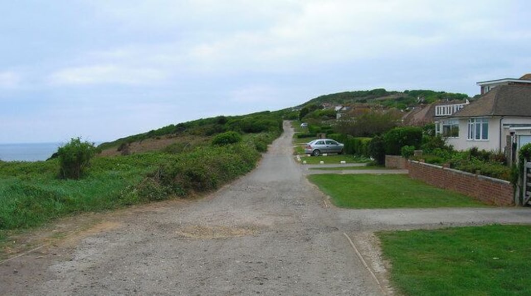Channel Way, Fairlight Cove An unmade road that marks the boundary of the settlement of Fairlight Cove from the cliff top to the south. The Firehills can be seen in the background. The eastern part of this road has now been closed due to cliff erosion.