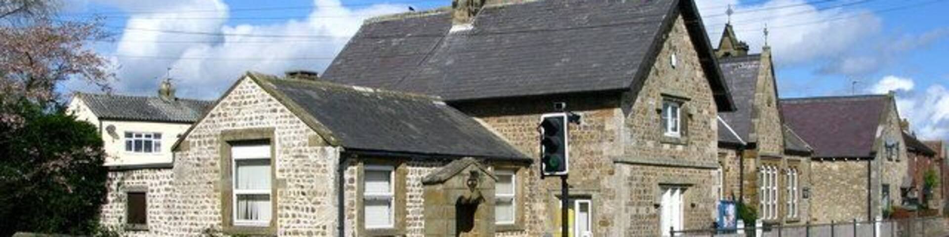North Stainley Village Beside the main road, the village pinfold appears to have been incorporated into the churchyard behind the near wall, the adjacent low building has an 1842 date stone and may have been the original school before the larger building was erected in 1871. The far building was formerly a Methodist Chapel.