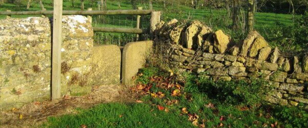 Squeeze stile - Chiselborough This stile is located in Church Lane at the start of a footpath. Over the fence is an old apple orchard and beyond that the houses in North Lane are visible below Chiselborough Hill.