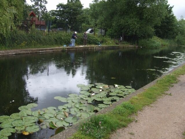 Fishing in the rain on the Curly Wyrley Fishermen at the visitor moorings at Lane Head on the Wyrley and Essington Canal.