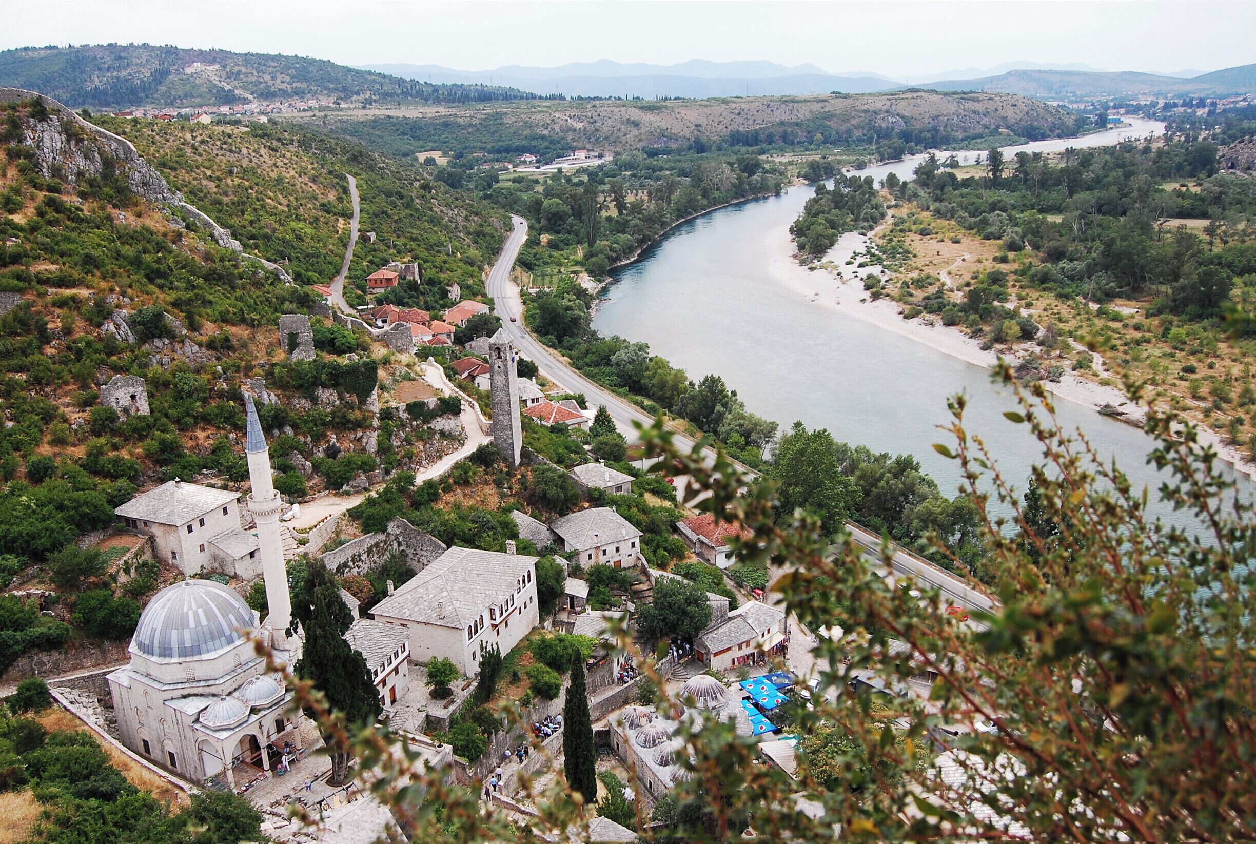 'Located on the left bank of Neretva River, it is believed that the fortified complex was built in 1383 by Bosnia's King Stjepan Tvrtko I. Medieval and Ottoman-Mediterranean influences can be clearly traced here.
Local's Tip: Lose yourself in the streets of the fortified town, which is a very well preserved one, climb into the top of the highest construction and play a game of shadows and lights with your camera. 
Watch the local artists and craftsmen in action and choose some of the handmade souvenirs to take home with you.
Last but not least, don't forget to explore the surrounding hills, full of pomegranate trees.'