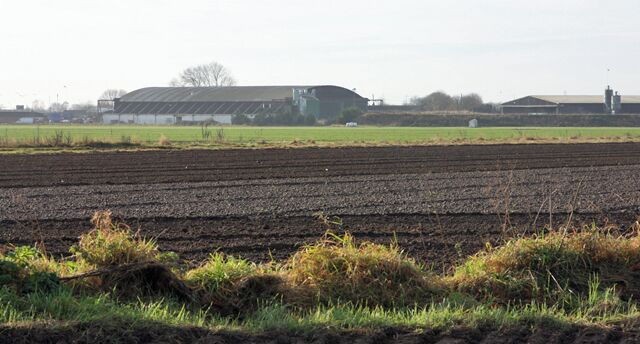 Pocklington Industrial Estate, Barmby Moor, East Riding of Yorkshire, England. This southwesterly view is seen from the layby on Barmby Road (B1246), west of Pocklington. The foreground field is arable, and the green area is the airstrip for Pocklington Gliding Club. On the OS 1:25,000 this is named "Hodsow Field".
