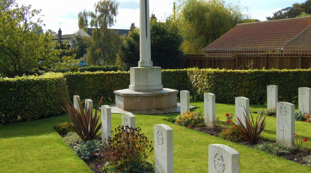 Cross of Sacrifice and some of the Commonwealth War Graves Commission headstones in St Catherine's parish churchyard, Barmby Moor, East Riding of Yorkshire, England. Most of the graves are of airmen who died in the Second World War. They include members of the RAF, RAAF, RNZAF and RCAF.