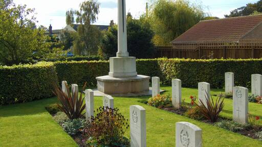 Cross of Sacrifice and some of the Commonwealth War Graves Commission headstones in St Catherine's parish churchyard, Barmby Moor, East Riding of Yorkshire, England. Most of the graves are of airmen who died in the Second World War. They include members of the RAF, RAAF, RNZAF and RCAF.