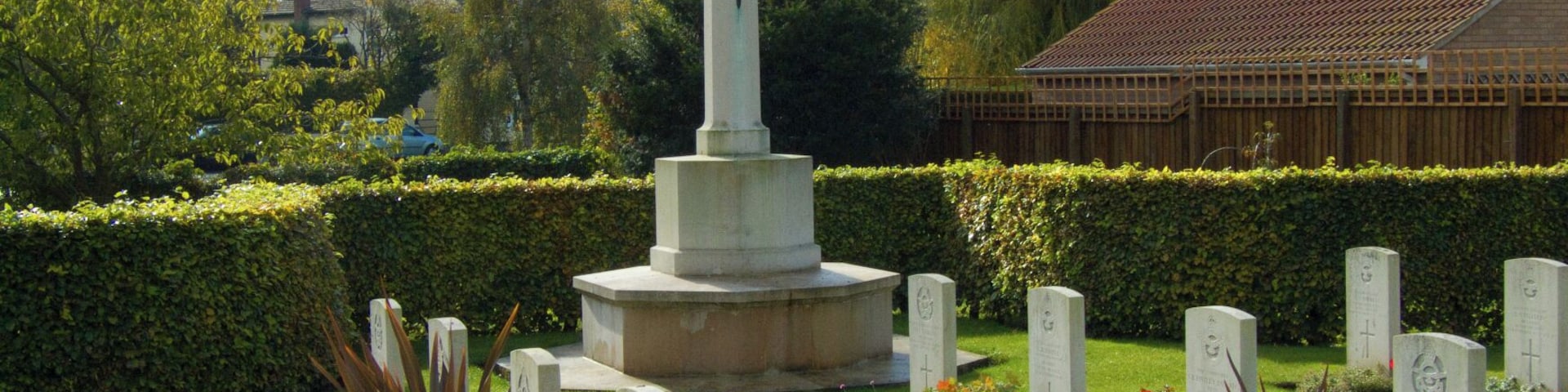 Cross of Sacrifice and some of the Commonwealth War Graves Commission headstones in St Catherine's parish churchyard, Barmby Moor, East Riding of Yorkshire, England. Most of the graves are of airmen who died in the Second World War. They include members of the RAF, RAAF, RNZAF and RCAF.