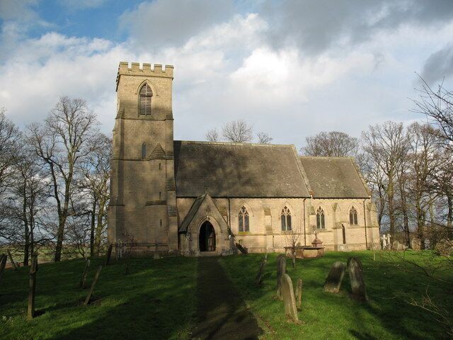 A church with a tall tower and a large arched entrance.