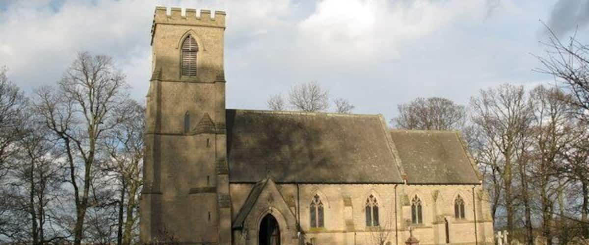 A church with a tall tower and a large arched entrance.