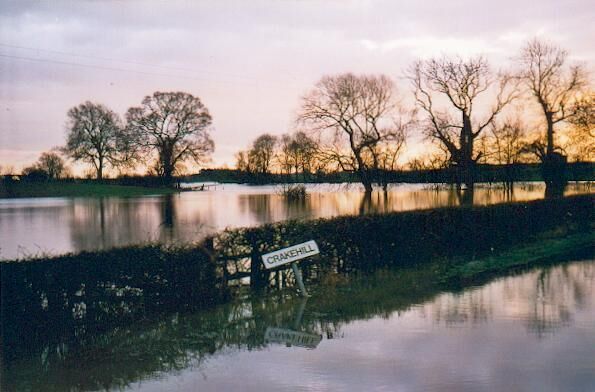 River Swale in flood Crakehill. Floods back up a tributary stream to cut the road leading to the hamlet of Crakehill near Thirsk.