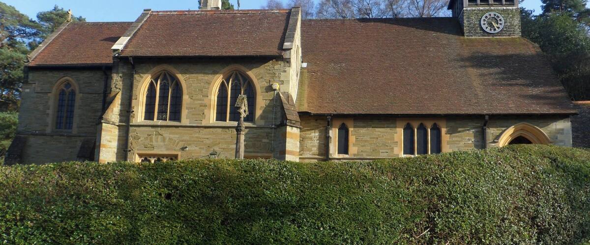 A church with a clock tower and arched windows.