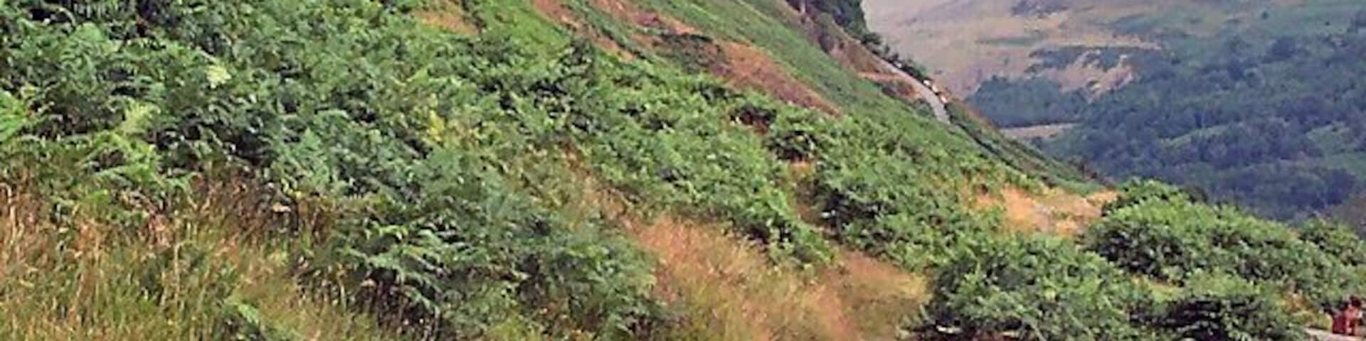 Troed-y-rhiw mountain. Above Ynyshir looking northwards along the footpath looking towards a distant minor road climbing the mountainside